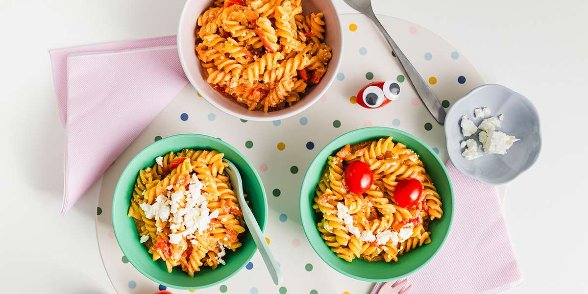 One Pot Feta Tomaten Pasta auf 3 Teller angerichtet. Ein Teller ist mit 2 Tomaten und einem Mund aus Feta kindgerecht dekoriert.